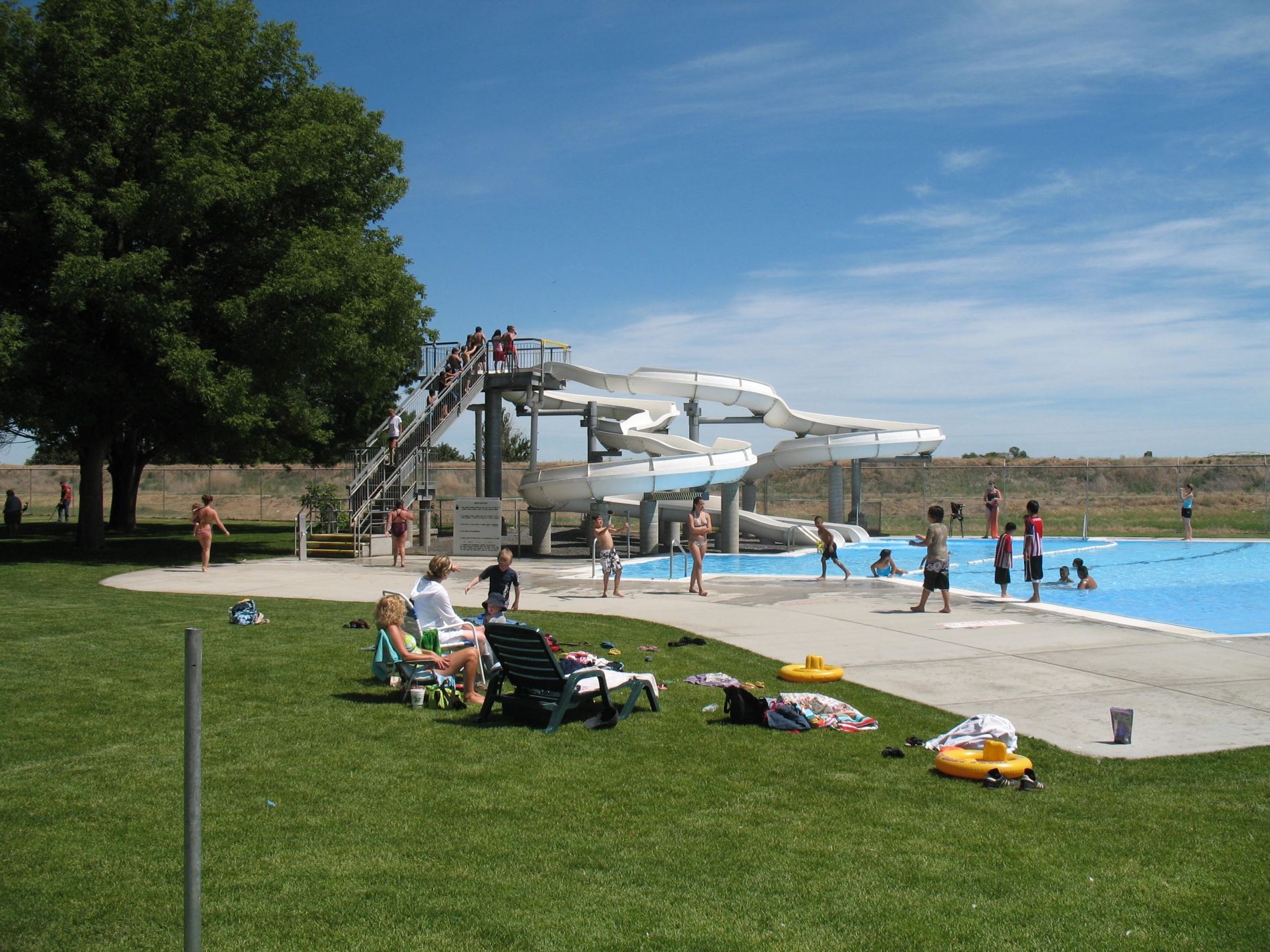 Kids playing the water by a water slide